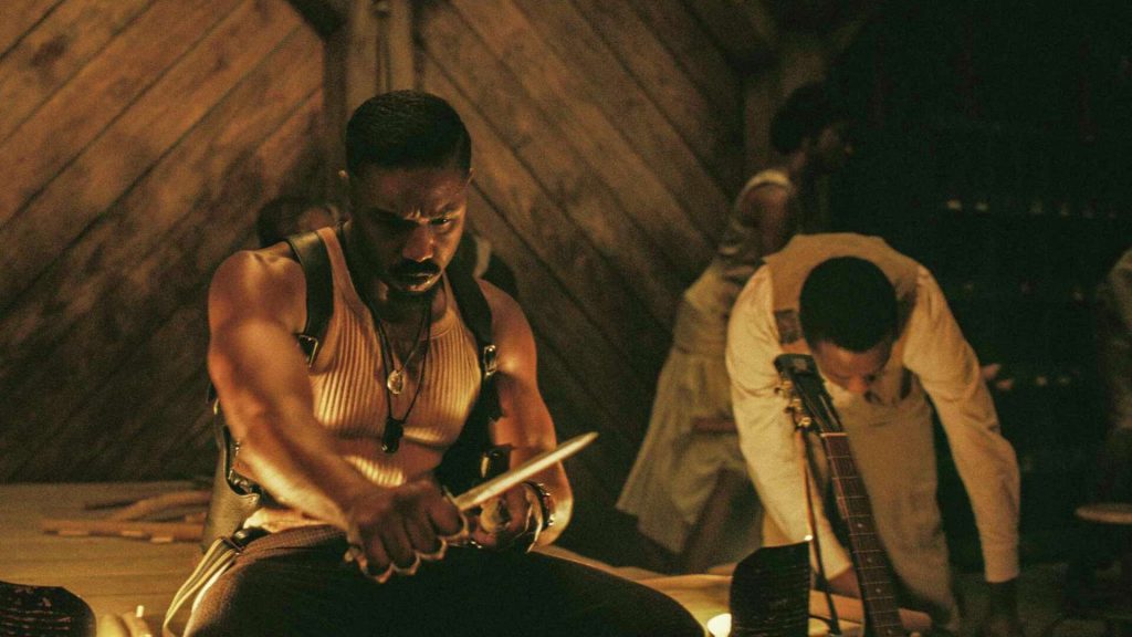Michael B Jordan sharpens a stake.