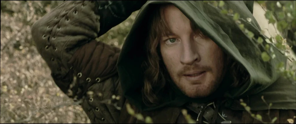 Faramir reaches behind his back to draw his sword.